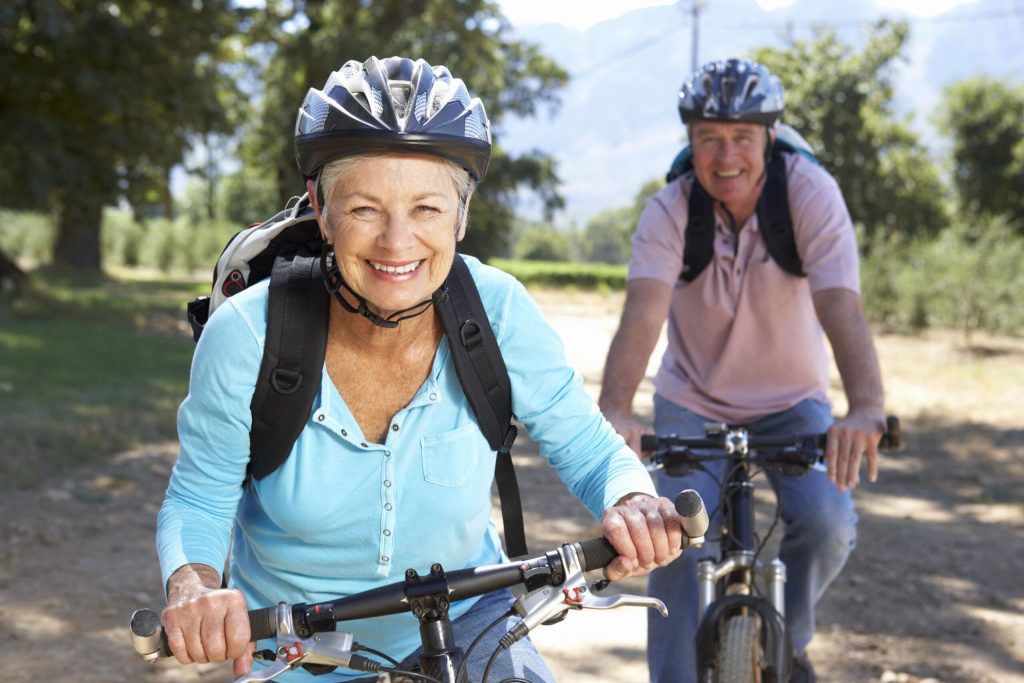 exercise to boost mental health, couple riding bicycles