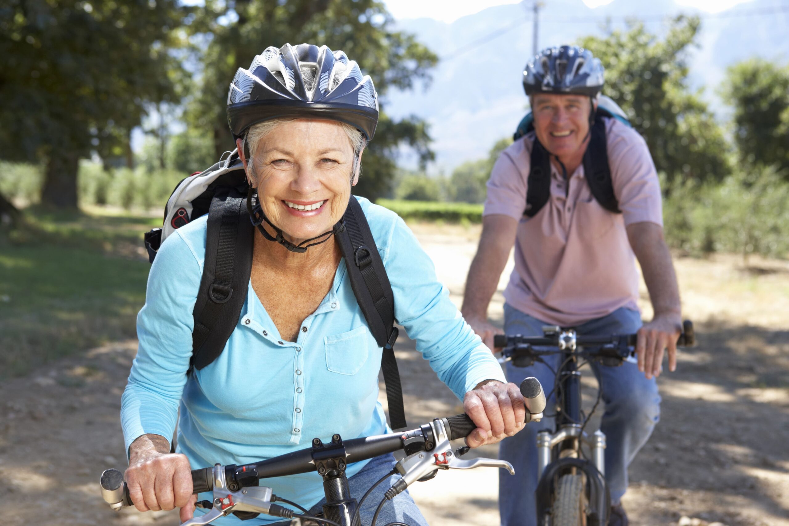 exercise to boost mental health, couple riding bicycles