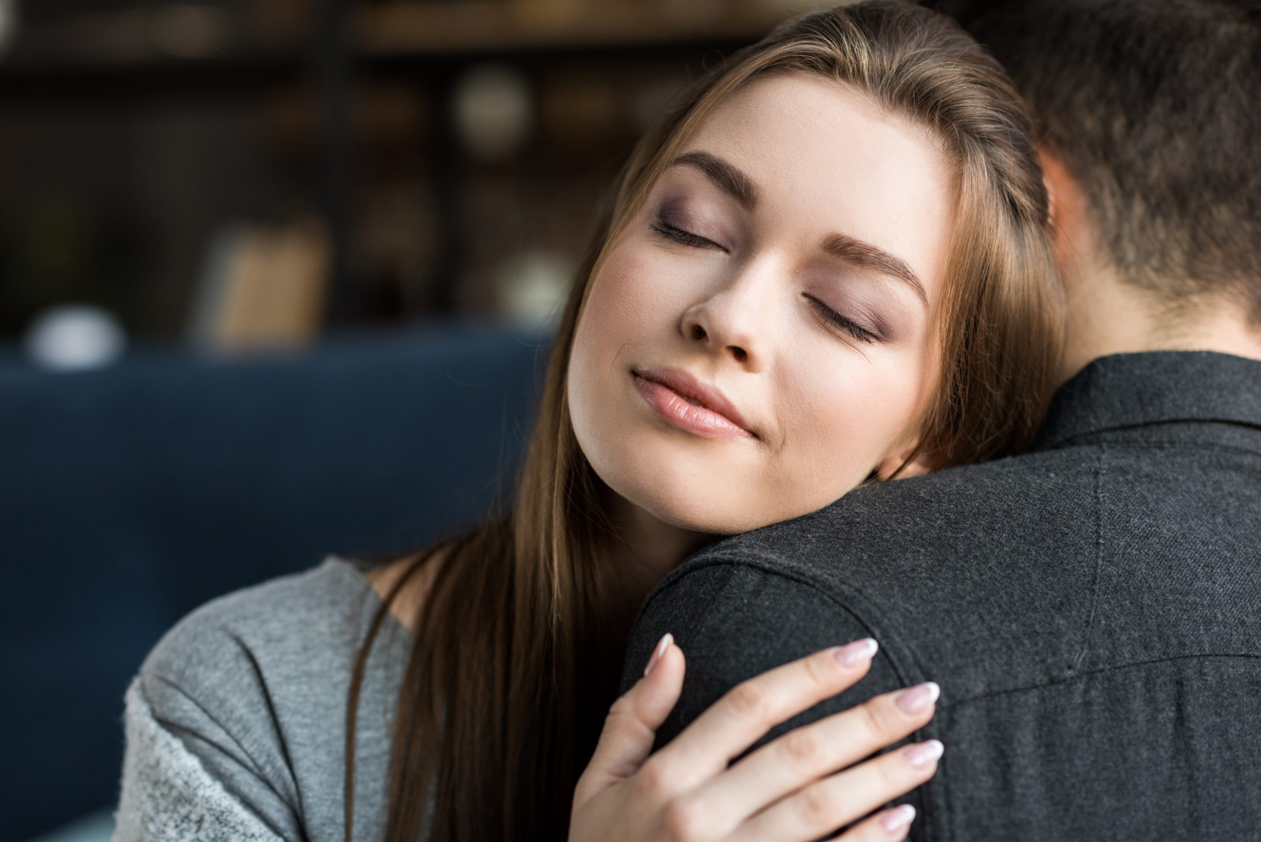 Better relationships, woman hugging man, peaceful face