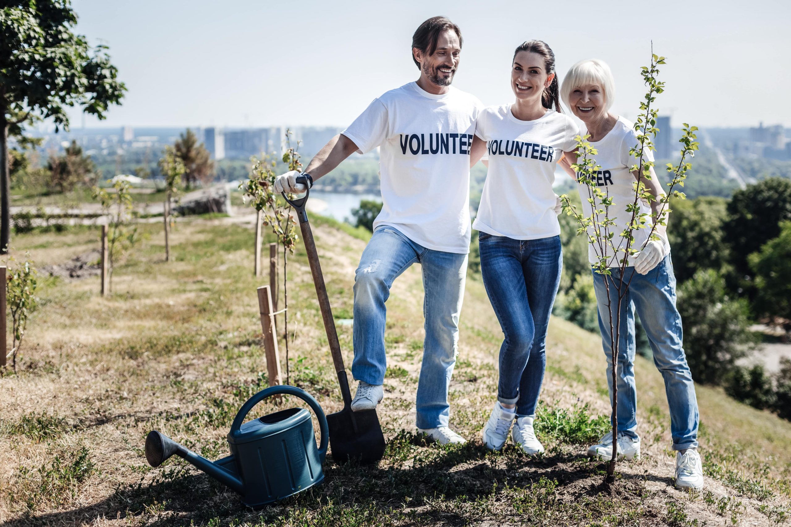 Dealing with loneliness for btter mental health. Group of volunteers working together to plant trees.