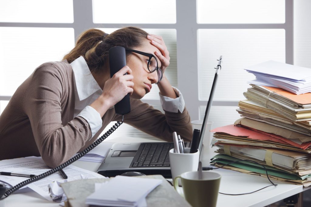 How to Manage Workplace Stress 7 workplace stress, woman at desk stressed