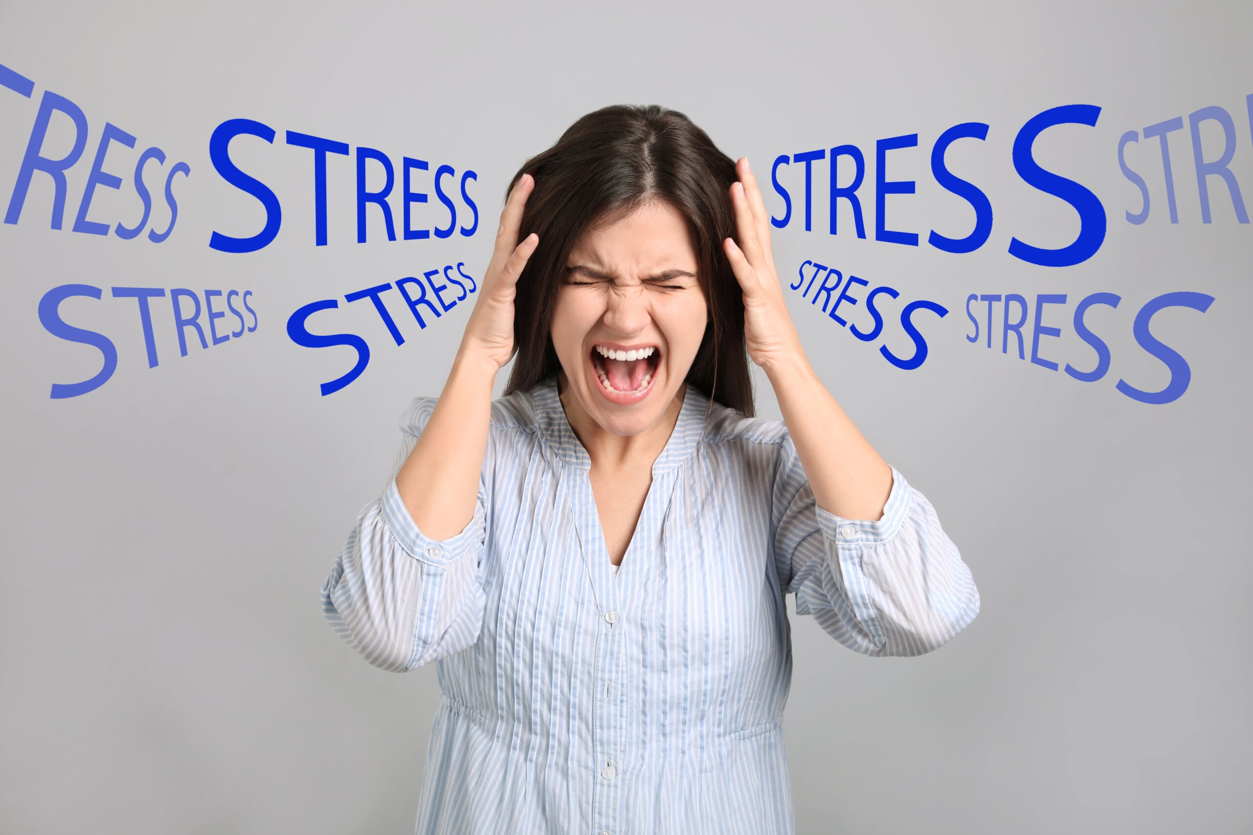 woman with chronic stress, screaming and grabbing her head