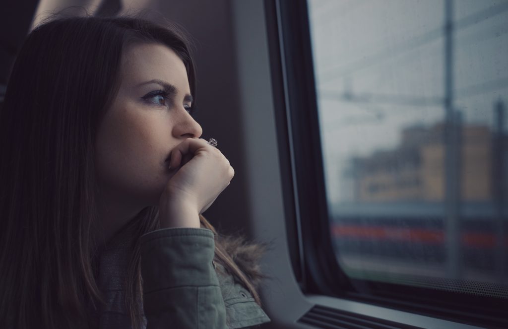teen looking wistfully out a window