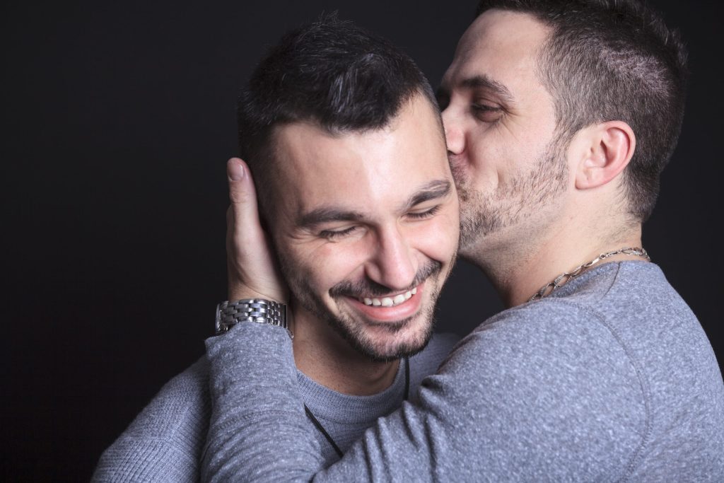 Navigating Sexual Orientation and Mental Health 15 sexual orientation - two men embracing, one kissing the other on the cheek